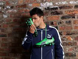 Sergio Aguero holding a pair of Puma football boots